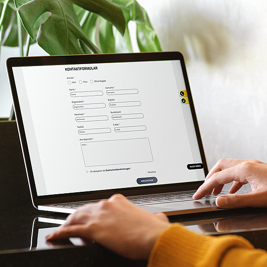 ©Woman In Yellow Cardigan Uses Her Laptop Female Hands Working On Laptop With White Blank Isolated S… Tatiana Lavrova / Getty Images