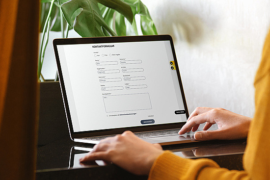 ©Woman In Yellow Cardigan Uses Her Laptop Female Hands Working On Laptop With White Blank Isolated S… Tatiana Lavrova / Getty Images
